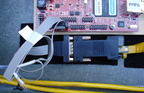 Custom Serial Cable (grey), Serial to Ethernet Adapter (black) and Ethernet Cable (yellow)